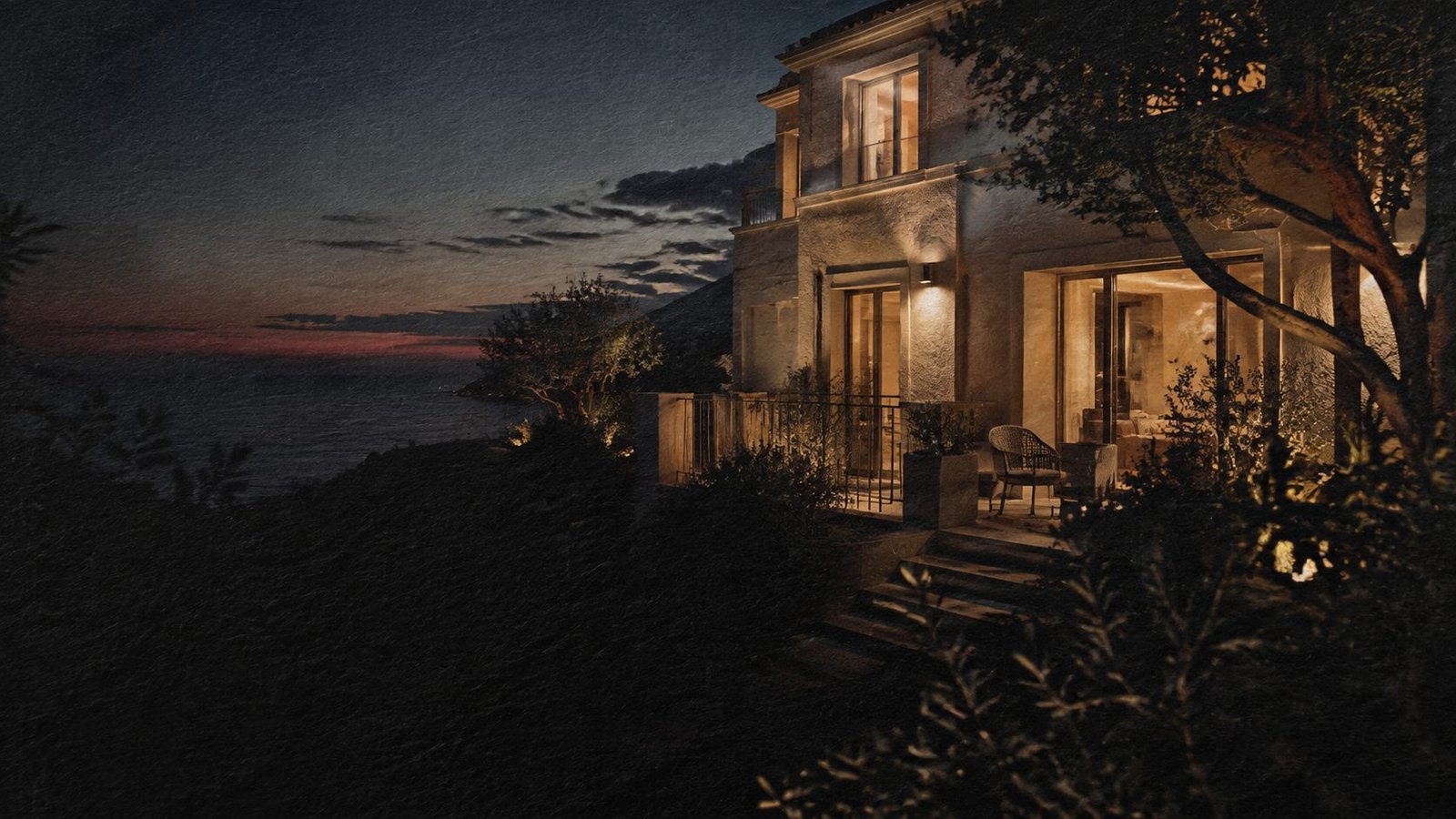 A guesthouse on the Atlantic Seaboard at dusk, lights on in every room.